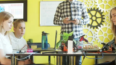 Young students and teacher with robot in classroom Stock Footage 140765943