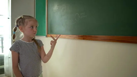Young students are calculating the result of numbers to write the answer Stock Footage 340907978