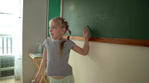 Young students are calculating the result of numbers to write the answer Stock Footage 340908265