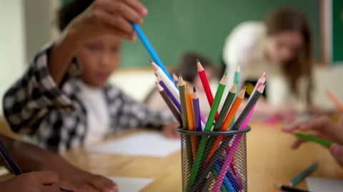 Young students are learning to draw and sketch with colored pencils Stock Footage 340829176