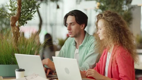 Young students discussing data on laptops Stock Footage 142485352
