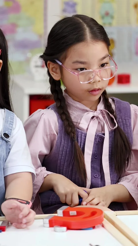 Young Students Exploring Magnetic Force During Science Experiment in Classroom Stock Footage 328346117