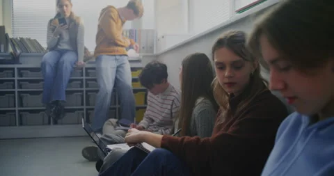 Young Students Gather on Floor, Engaged in Active Discussion and Note Taking Stock Footage 321013067