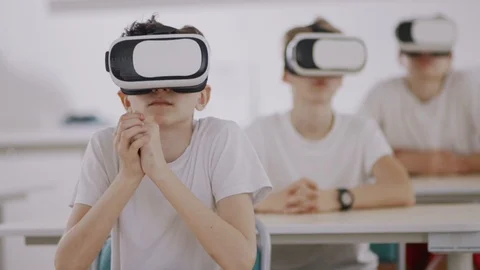 Young students having a futuristic computer science class with VR headsets in Stock Footage 111970231
