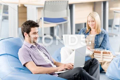 Young students at high-school working on laptop Stock Photos