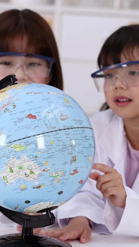 Young Students in Lab Coats Studying World Globe in Science Class Stock Footage 342087224