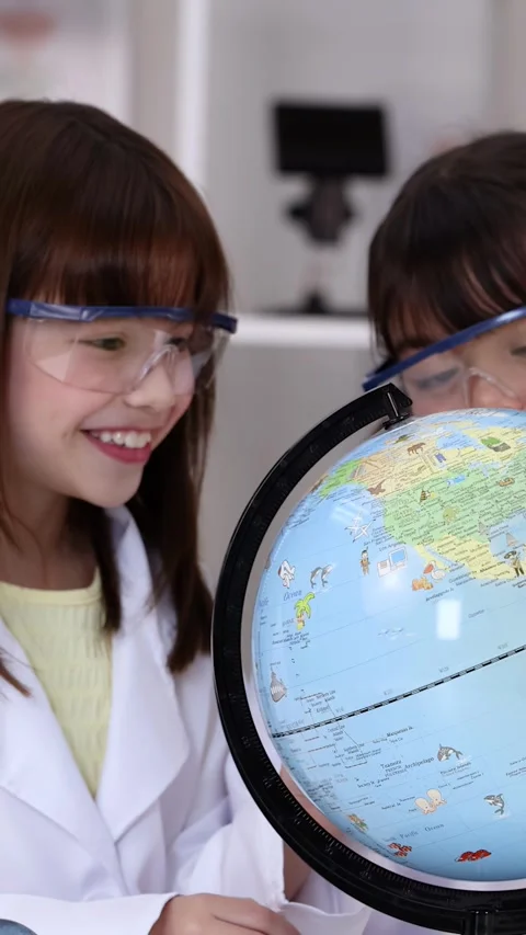 Young Students in Lab Coats Studying World Globe in Science Class Stock Footage 342090368