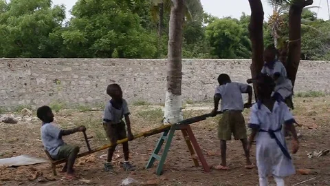 Young students playing in a broken carousel Vídeos de archivo 69234481