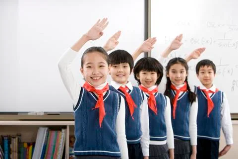 Young students saluting in a row at school Stock Photos