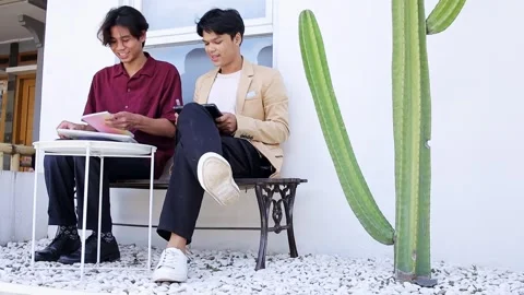 Young Students sharing knowledge and ideas outdoors while studying and 動画素材 319757248