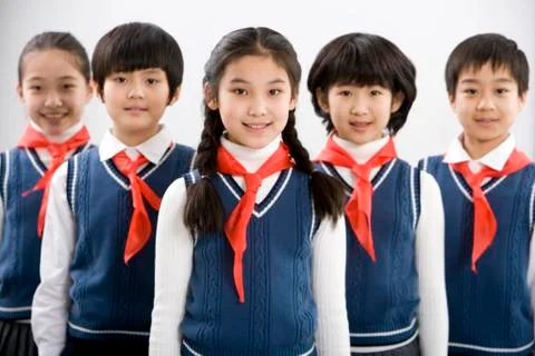 Young students standing in a row at school Stock Photos