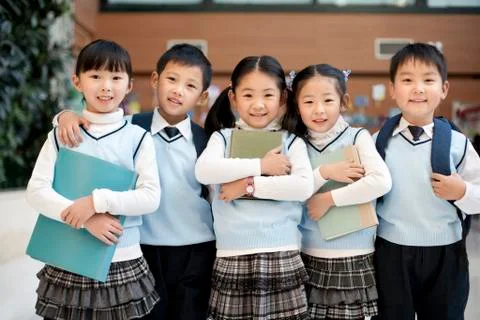 Young students standing in a row at school Stock Photos