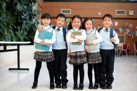 Young students standing in a row at school Stock Photos