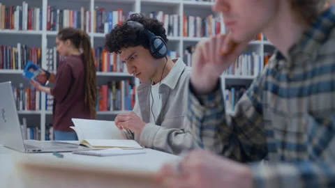 Young students studying and researching in university library 스톡 동영상 335124814