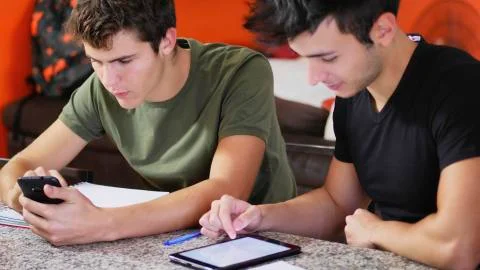 Young students studying with gadgets Stock Photos