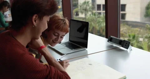 Young students studying inside university library Stock Footage 203720453