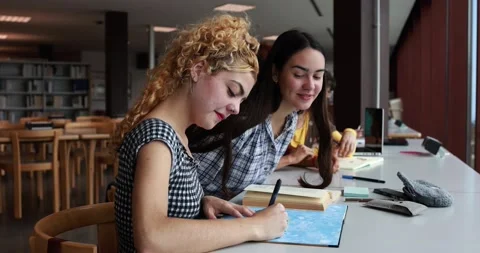 Young students studying inside university library Stock Footage 203721334