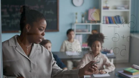 Young Students Studying Math Problems on Transparent Board in Classroom Stock Footage 312053632