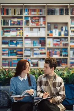 Young students studying together in a library setting Stock Photos