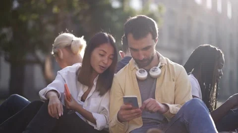 Young students using phones while studying outdoor Stock Footage 163282270
