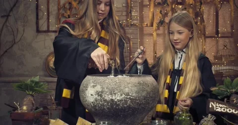 Young students of the wizard school are brewing a potion in a big pot, 4k Stock Footage 149036313