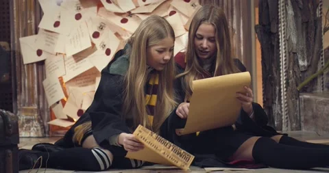 Young students of the wizard school are sitting on the floor and reading, 4k Stock Footage 149036343