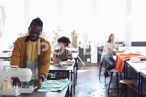 Young students working on projects at a fashion college Stock Photos