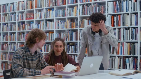 Young students working together on a group project in a university library Video stock 335131442