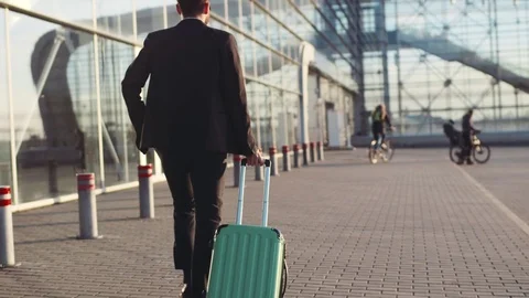 Young Traveler Man Dragging Luggage At Airport Stock Photo