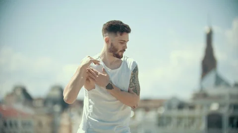 Young stylish bearded man with tattoos in white shirt performing locking dance Stock Footage 112158606