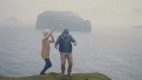 Young stylish couple having fun together. Man and woman dancing on the shore of Stock Footage 83008886