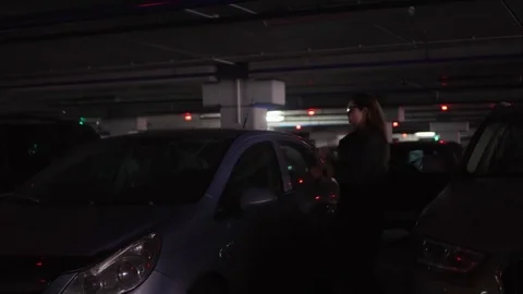 Young stylish female gets out of the car, closes it and goes to the parking lot Stock Footage 80723539