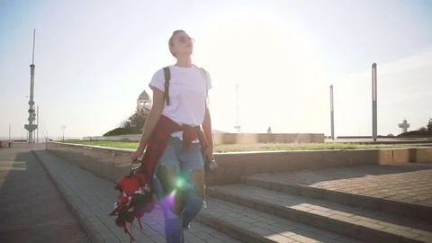 Young stylish funky girl with green hair walking with roller skates near sea Stock Footage