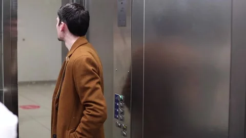 A young stylish guy rises in an elevator. Stock Footage 233032005