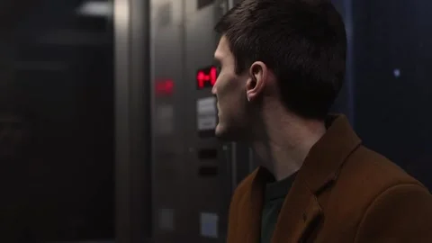 A young stylish guy rises in an elevator. Stock Footage 234230424