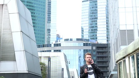 Young stylish man with a backpack walking down the street. Stock Footage 97045802