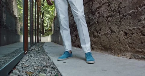 A young stylish man, dressed in light clothes looking very confident Stock Footage 142462777