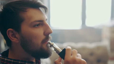 Young stylish man with electronic cigarette vaping 스톡 동영상 63163987