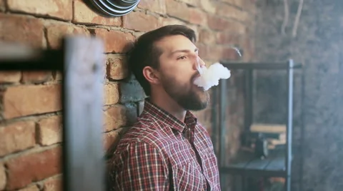 Young stylish man with electronic cigarette vaping Stock Footage 63484494