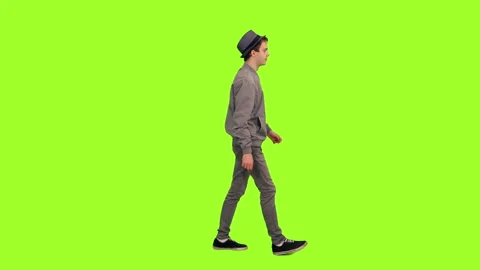 Young stylish man in hat walking on green chroma key background Stock Footage 92798742