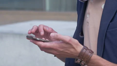 Young stylish man using a phone outdoors in the city Stock Footage 132931955