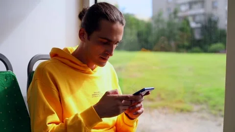 Young stylish man using smartphone mobile in bus. Traveling by public transport 動画素材 135453762