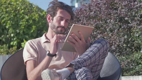 Young stylish man using a tablet outdoors in the city Stock Footage 132912732