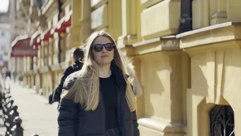 Young stylish pretty beautiful smiling woman walking in big modern city, having Stock Footage 305391908