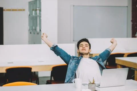 Young stylish student with beard working on laptop Stock Photos