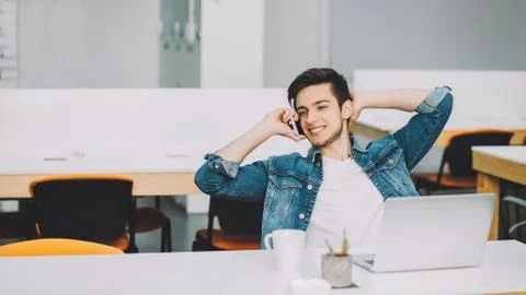 Young stylish student with beard working on laptop Stock Photos
