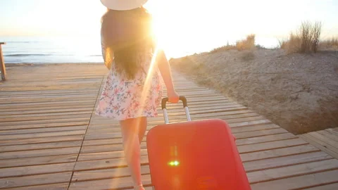 Young stylish woman running with red suitcase. Vacation concept Stock Footage 89397853
