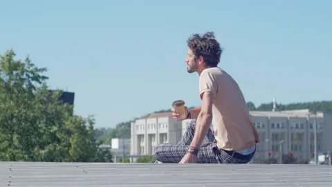 Young stylish worker taking a coffee break outdoors Stock Footage 132833610