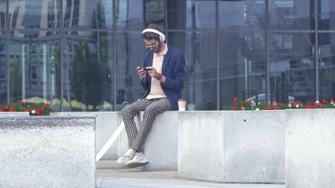 Young stylish worker taking a coffee break outdoors Stock Footage 132929224