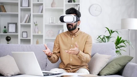 Young successful freelancer businessman using VR glasses for video call and chat Stock Footage 252214973